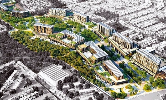 The image shows a panoramic view of a large area with buildings. Four very large buildings surrounded by vegetation, trees, and pools stand out, giving it the appearance of a residential area. More buildings can be seen on the sides.